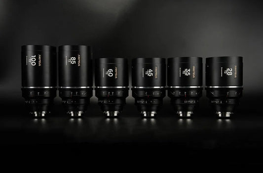 Four Laowa lenses on black background: 35mm, 45mm, 60mm, 85mm with amber flare.